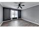 A bedroom featuring wood-look floors, a ceiling fan, crown molding and natural light at 4580 Lakefield Bend Bnd, Berkeley Lake, GA 30096
