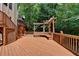Multi-level deck boasts built-in seating with a pergola, offering a serene escape into a private wooded setting at 4580 Lakefield Bend Bnd, Berkeley Lake, GA 30096