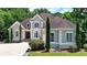 Charming two-story home with a well-maintained lawn, mature trees, and a welcoming front entrance at 4580 Lakefield Bend Bnd, Berkeley Lake, GA 30096