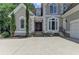 Inviting front entrance with a double-door entry, beautiful trim, and a well-manicured lawn at 4580 Lakefield Bend Bnd, Berkeley Lake, GA 30096