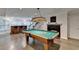 View of the game room and bar area featuring a pool table, fireplace, and bar with seating at 4580 Lakefield Bend Bnd, Berkeley Lake, GA 30096
