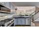 The kitchen with granite countertops is modern with stainless appliances and light gray cabinets at 4580 Lakefield Bend Bnd, Berkeley Lake, GA 30096