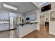 Stylish kitchen with stainless steel appliances, breakfast bar, and an open layout to the living room at 4580 Lakefield Bend Bnd, Berkeley Lake, GA 30096