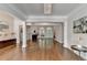 Open-concept living space featuring hardwood floors, fireplace, built-in shelving and plenty of natural light at 4580 Lakefield Bend Bnd, Berkeley Lake, GA 30096