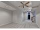 Bonus living space with ceiling fans, neutral carpet, and staircase at 4580 Lakefield Bend Bnd, Berkeley Lake, GA 30096