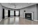 Living room featuring a fireplace, ceiling fan and wood floors at 4580 Lakefield Bend Bnd, Berkeley Lake, GA 30096