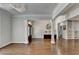 Open living area with rich hardwood floors, view of front door, built-in bookshelves, and abundant natural light at 4580 Lakefield Bend Bnd, Berkeley Lake, GA 30096