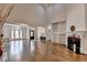 Bright, open living room with hardwood floors, built-in shelving, fireplace, and high ceilings with chandelier at 4580 Lakefield Bend Bnd, Berkeley Lake, GA 30096