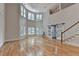 Bright, open living room boasts hardwood floors, and sliding barn doors leading to the fireplace and high ceilings at 4580 Lakefield Bend Bnd, Berkeley Lake, GA 30096