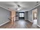 A loft area with wood-look floors, crown molding, and a staircase at 4580 Lakefield Bend Bnd, Berkeley Lake, GA 30096