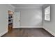 A room shows hardwood floors with neutral walls, and leads into the kitchen at 4580 Lakefield Bend Bnd, Berkeley Lake, GA 30096