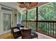 Relaxing screened porch with wicker seating and wooded views, perfect for enjoying the outdoors in comfort at 4580 Lakefield Bend Bnd, Berkeley Lake, GA 30096