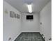 Finished Storage area with gray tiled flooring and a flat screen television at 4580 Lakefield Bend Bnd, Berkeley Lake, GA 30096