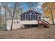 View of backyard featuring a screened in porch and mature trees at 7463 Lerose Dr, Jonesboro, GA 30236