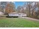 Cozy one-story home with a long driveway and luscious lawn in a wooded neighborhood at 7463 Lerose Dr, Jonesboro, GA 30236