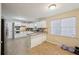 Bright kitchen featuring white cabinets, tile flooring, and an island with granite countertops at 7463 Lerose Dr, Jonesboro, GA 30236