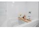 Bright bathroom showcases tub with tray, candle, flowers, and white subway tile at 788 W Marietta Nw St # 1302, Atlanta, GA 30318