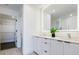 Bathroom features a double vanity, a large mirror, and a doorway to the closet at 788 W Marietta Nw St # 1302, Atlanta, GA 30318