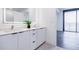 Double vanity bathroom featuring modern cabinets, large mirrors and hardwood floors at 788 W Marietta Nw St # 1302, Atlanta, GA 30318