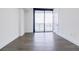Bright bedroom with hardwood floors and a sliding glass door to a balcony at 788 W Marietta Nw St # 1302, Atlanta, GA 30318