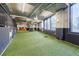 A spacious indoor dog park features an artificial turf surface and colorful murals for canine recreation at 788 W Marietta Nw St # 1302, Atlanta, GA 30318
