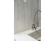 Dog wash station with stainless steel faucet and gray tile, offering convenient pet care at 788 W Marietta Nw St # 1302, Atlanta, GA 30318