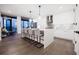 Modern kitchen with a large central island, white cabinetry, pendant lights, and stainless steel appliances at 788 W Marietta Nw St # 1302, Atlanta, GA 30318