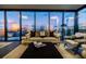Stylish living room featuring floor-to-ceiling windows with cityscape views, a comfortable sofa, and modern furnishings at 788 W Marietta Nw St # 1302, Atlanta, GA 30318