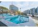 Inviting pool area featuring lounge chairs, a hot tub, and city views at 788 W Marietta Nw St # 1302, Atlanta, GA 30318