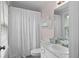 Bright and clean bathroom with shower curtain, white vanity and pink walls at 1540 Cedar Bluff Trl, Marietta, GA 30062