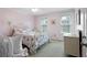 Pink bedroom features bed with floral accents, matching vintage dresser, and natural light at 1540 Cedar Bluff Trl, Marietta, GA 30062