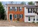 Inviting two-story brick townhouse with classic shutters and well-manicured landscaping at 1540 Cedar Bluff Trl, Marietta, GA 30062