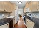 Galley kitchen featuring hardwood floors, stainless steel appliances, and beautiful countertops at 1540 Cedar Bluff Trl, Marietta, GA 30062