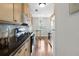 Galley kitchen with hardwood floors, stainless steel appliances, and dark granite countertops at 1540 Cedar Bluff Trl, Marietta, GA 30062