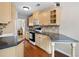 Well-lit kitchen with wood floors, stone backsplash, stainless steel appliances and cream cabinets at 1540 Cedar Bluff Trl, Marietta, GA 30062