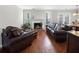 Comfortable living room with fireplace, hardwood floors, and view into the dining area at 1540 Cedar Bluff Trl, Marietta, GA 30062