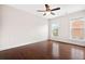 Bright bedroom features hardwood floors, a ceiling fan, and two windows letting in natural light at 1555 Brooksbank Dr, Brookhaven, GA 30319