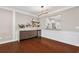 Dining area with hardwood floors, wainscoting, and an open view into the upgraded kitchen at 1555 Brooksbank Dr, Brookhaven, GA 30319