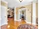 Inviting foyer with hardwood floors, decorative columns, and an office through the glass french doors at 200 Suffolk Way, Mcdonough, GA 30252