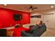 Entertainment room with a red accent wall, a TV, and comfortable seating perfect for relaxation and entertainment at 6510 Nw Long Island Nw Dr, Atlanta, GA 30328