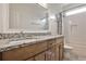 Elegant bathroom with a double vanity, granite countertops, and a bathtub with shower at 6510 Nw Long Island Nw Dr, Atlanta, GA 30328