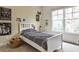 Well-lit bedroom with ample natural light, furnished with a bed and adorned with various wall decorations at 6510 Nw Long Island Nw Dr, Atlanta, GA 30328