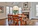 Inviting dining area featuring a wooden table, comfortable seating, natural light, and a decorative fireplace at 6510 Nw Long Island Nw Dr, Atlanta, GA 30328