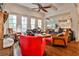 Bright living room features a fireplace, hardwood floors, large windows, and an open floor plan at 6510 Nw Long Island Nw Dr, Atlanta, GA 30328