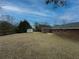 Expansive backyard featuring lush green space and a view of the home's rear exterior at 772 Garner Sw Rd, Lilburn, GA 30047