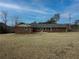 The backyard view shows a large, well maintained yard surrounded by trees, offering privacy at 772 Garner Sw Rd, Lilburn, GA 30047