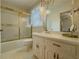 Bathroom with gold-framed shower glass and hanging lights above a white vanity at 772 Garner Sw Rd, Lilburn, GA 30047