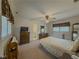 Bright bedroom featuring a ceiling fan, two dressers, and a view to the bathroom at 772 Garner Sw Rd, Lilburn, GA 30047