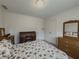 Bedroom featuring a floral bedspread, desk, and wood furnishings at 772 Garner Sw Rd, Lilburn, GA 30047