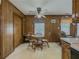 Cozy dining area with wood paneling and a ceiling fan for comfortable meals at 772 Garner Sw Rd, Lilburn, GA 30047